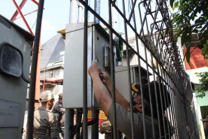 
					Satpol PP Kota Depok saat melakukan penyegelan tower di wilayah Kecamatan Cimanggis. (Foto: Istimewa)