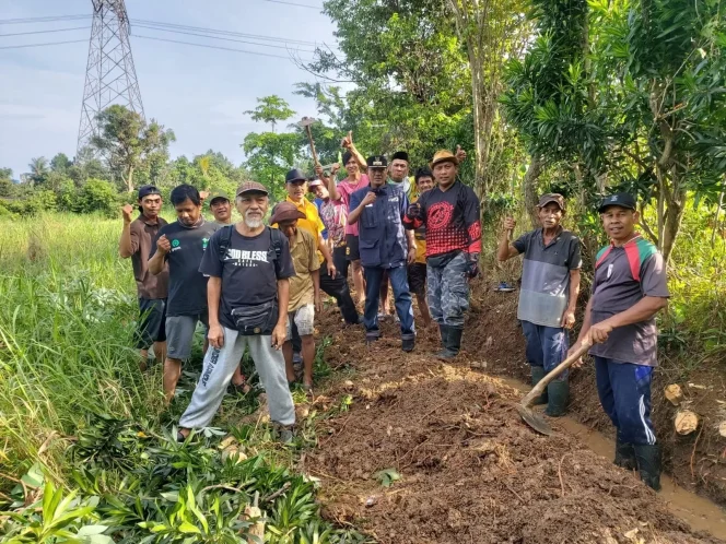 
					Lurah Bojongsari Baru, Syarifudin, bersama warga saat membersihkan saluran air di RT 02, RW 08, Minggu (05/02) kemarin. (Foto : Istimewa)