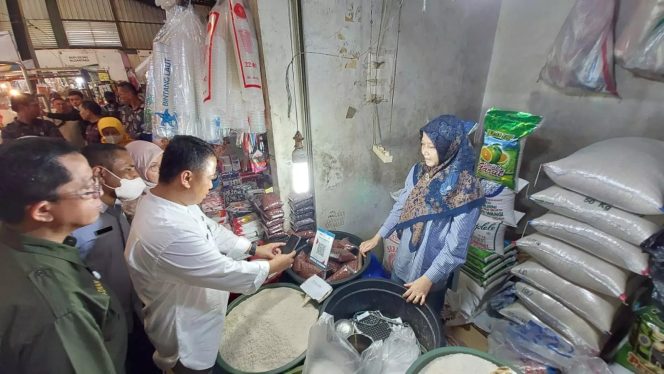 
					Sekda Kota Depok, Supian Suri melakukan pembayaran digital menggunakan QRIS kepada salah satu pedagang beras di Pasar Sukatani, Kecamatan Tapos, Selasa (21/03/23). (Foto : Diskominfo).