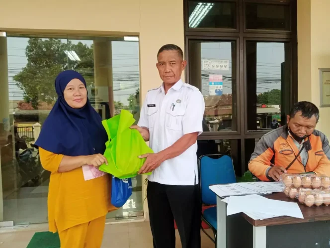 
					Sekretaris Lurah Cilangkap, Sarifudin menyerahkan bantuan pangan kepada orang tua yang memiliki anak stunting di halaman Kantor Kelurahan Cilangkap, Rabu (26/07/23). (Foto : Diskominfo).