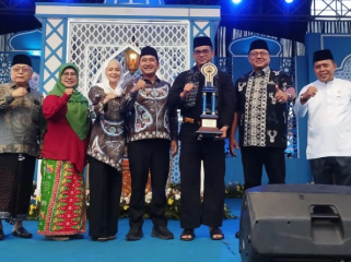 Camat Cipayung, M.Reza memegang Piala Bergilir kMTQH Kota Depok yang diserahkan oleh Wakil Wali Kota Depok, Chandra Rahmansyah, Kamis (13/11/25). (Foto: JD 01/Diskominfo)